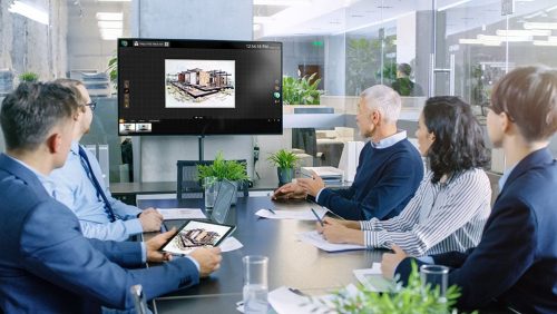 Diverse Group of Successful Business People in the Conference Ro Diverse Group of Successful Business People in the Conference Room with Green Screen Chroma Key TV on the Wall. They Work on a Company's Growth, Share Charts and Statistics.